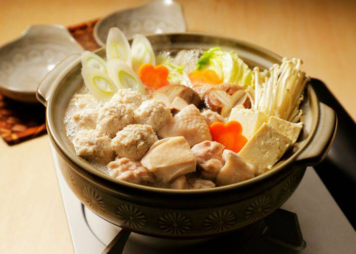 Chanko nabe, with meats, tofu, and veggies bubbling away in a hot pot broth.
